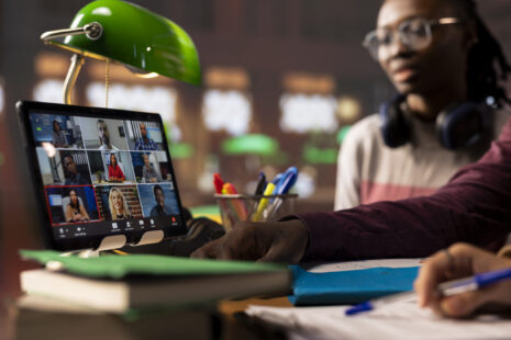 Group of diverse pupils engaging in an online course discussion via video call